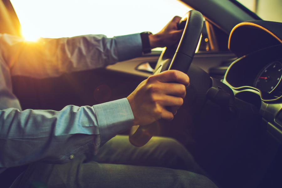 Tight shot of driver holding the steering wheel